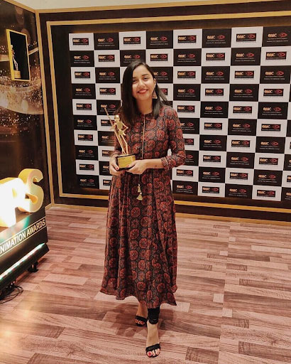 Prajakta Koli Holding an Award