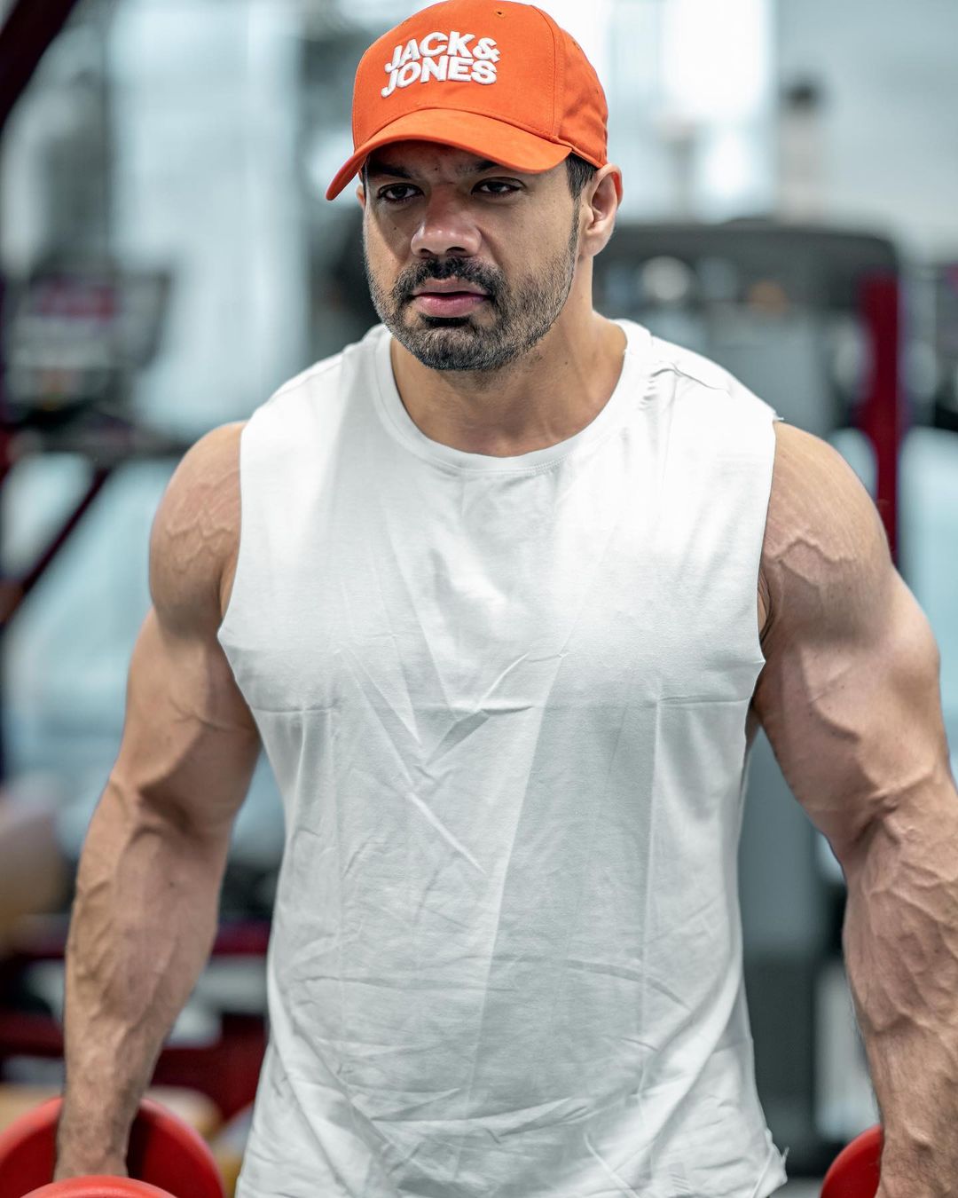 Gaurav Taneja one of the Top Health Influencers of India in White Tank and Orange Cap