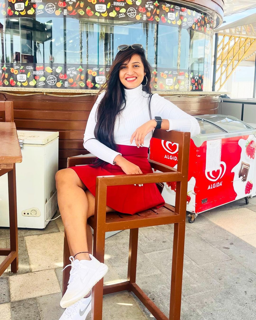 Photo of Dr Snehal Adsule a Wellness Coach and Female Health Influencer in a White Long Sleeves Top and Red Skirt