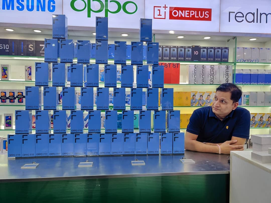 Praval Sharma the founder of Sharmaji Technical YouTube Channel in a Mobile Phone Store