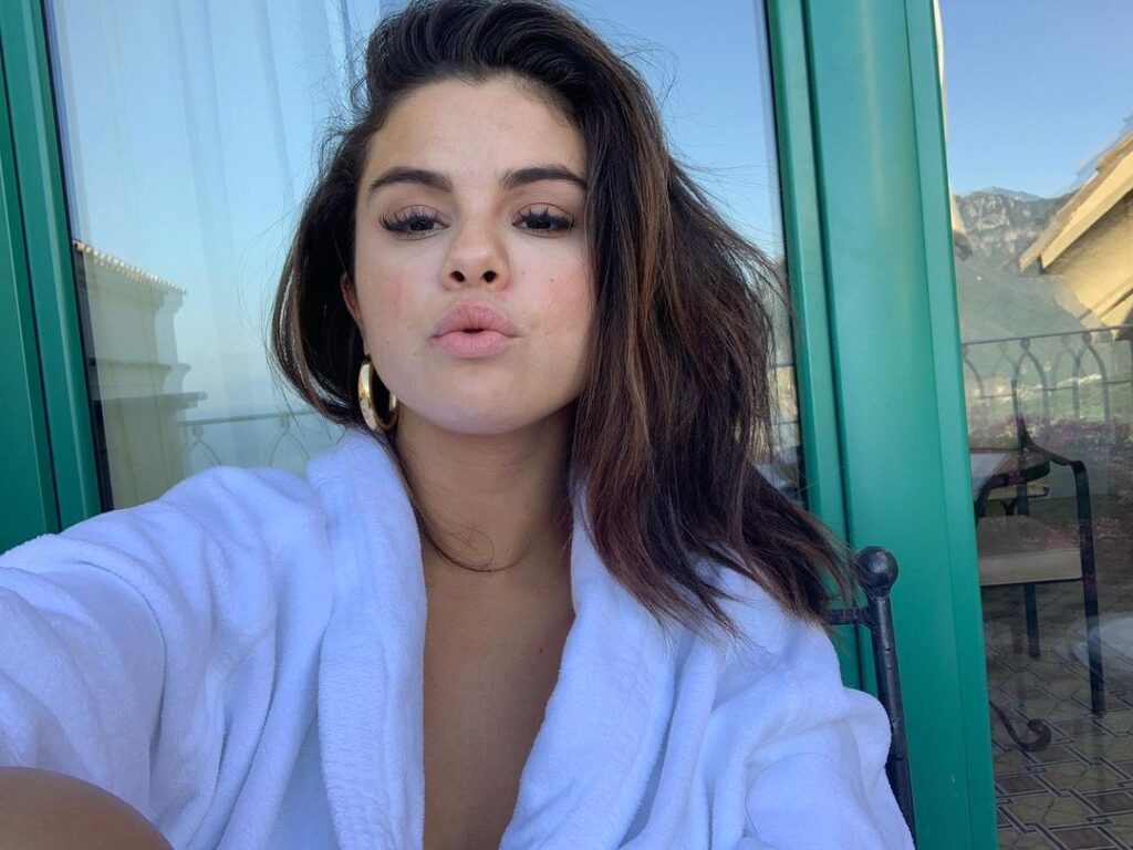 Selena Gomez Wearing a white bathrobe looks sexy