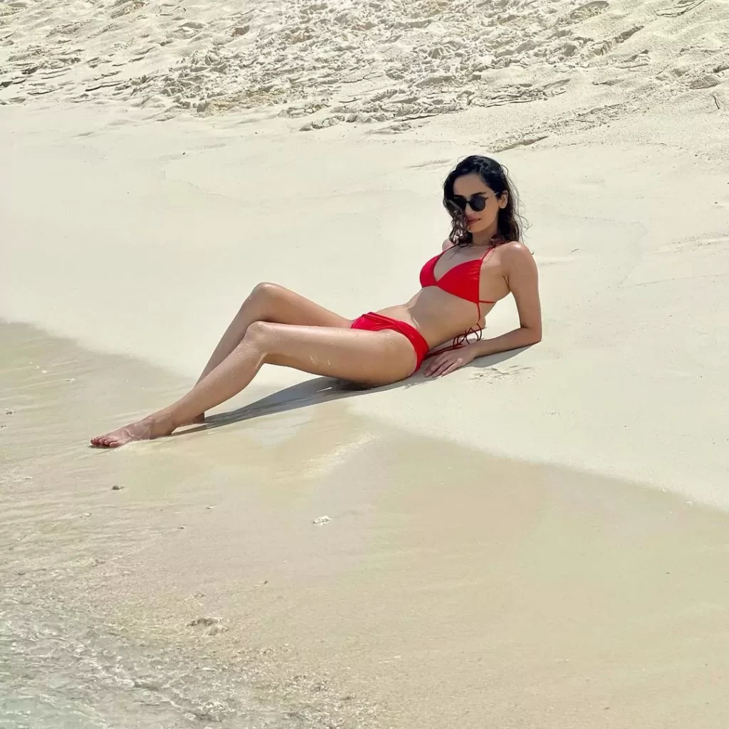 Manushi Chhillar on the beach wearing a red bikini hd Image biographia